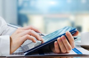person using a touch screen tablet